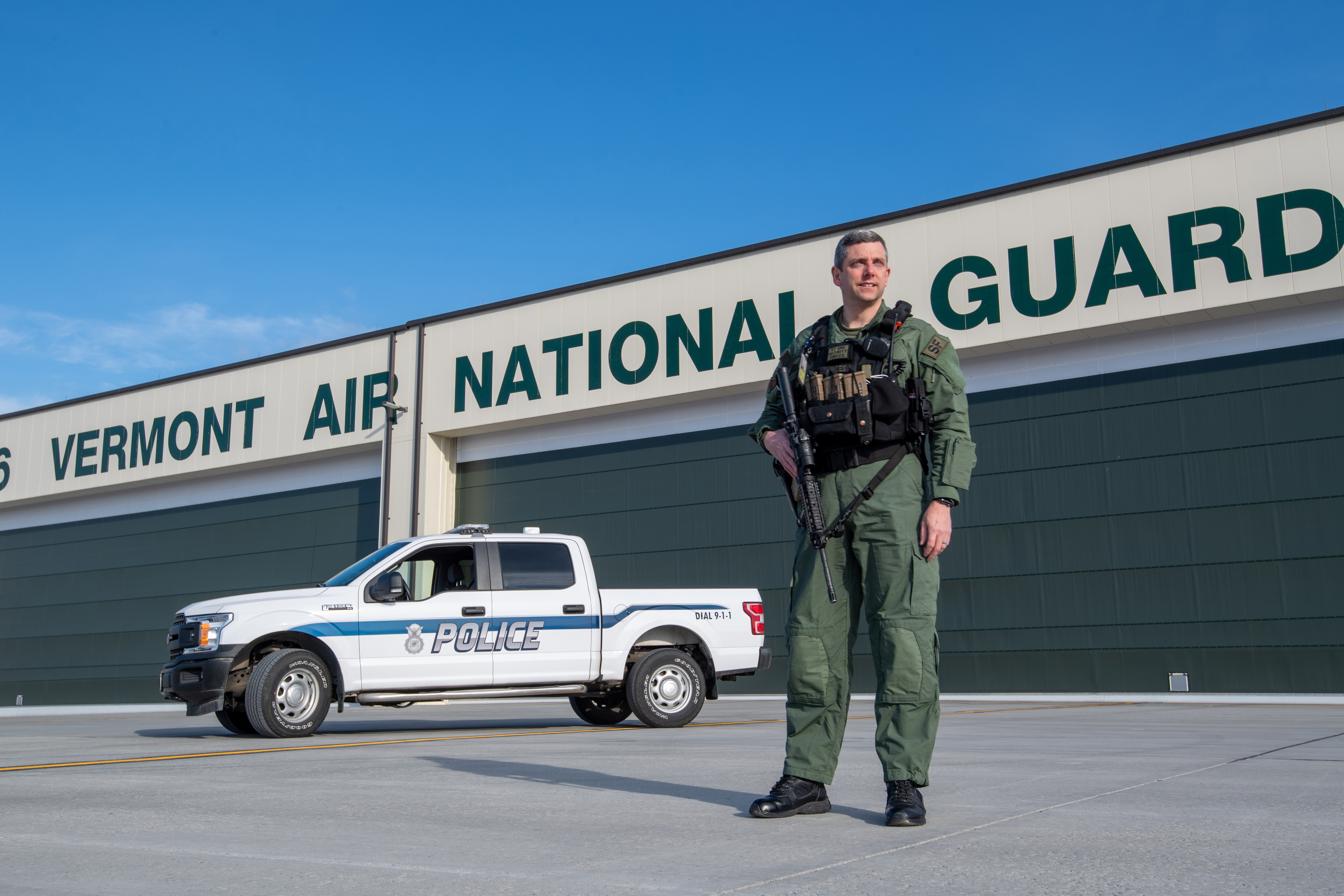 Force protection officer in front of hanger